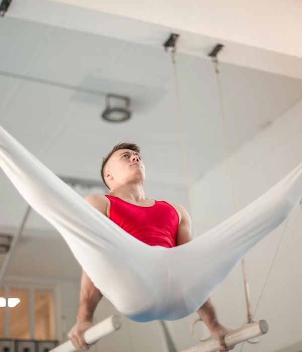A focused man performing a core strength exercise in a minimalist gym.