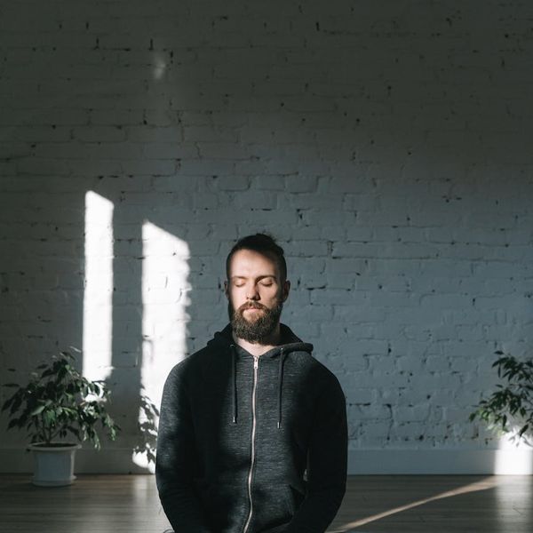 Man meditating in a calm environment, symbolizing mental focus and well-being.